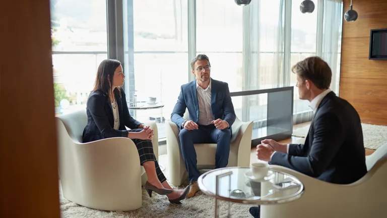 A legal team meets in office an office to discuss a medical license defense.