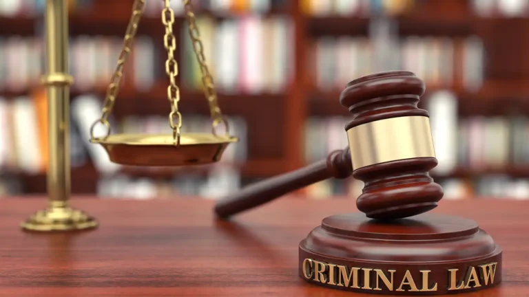 gavel that reads "criminal law" with scale in the background